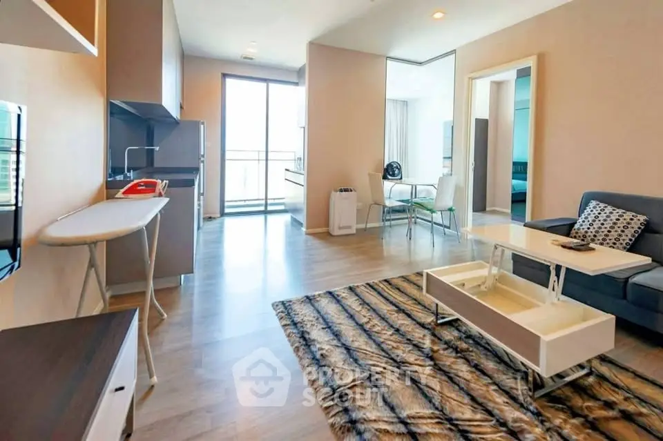 Modern living room with open kitchen and stylish decor in a bright apartment.
