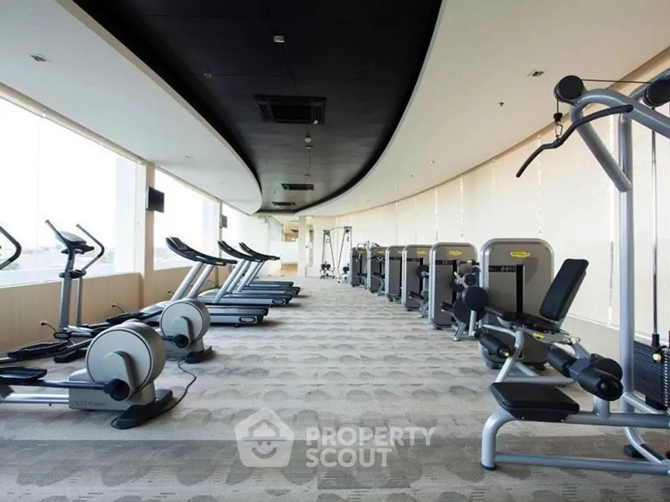 Spacious modern gym with state-of-the-art equipment and panoramic windows.
