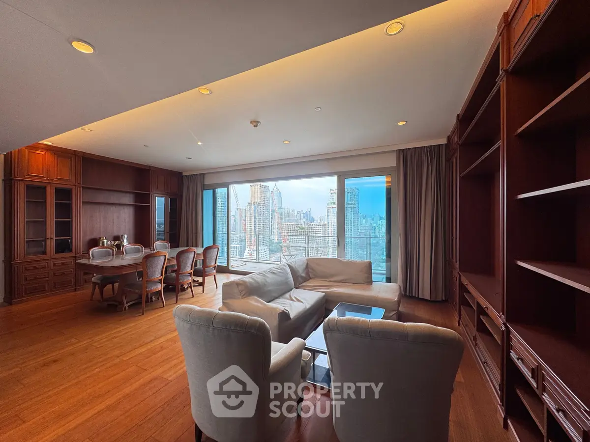Luxurious living room with stunning city view, elegant furniture, and spacious layout in high-rise apartment.
