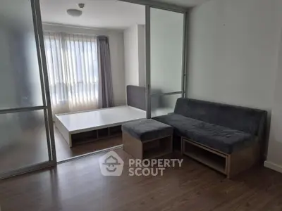 Modern studio apartment with sleek furniture and large windows