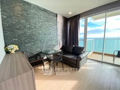 Stunning ocean view from modern living room with glass balcony, perfect for relaxation.
