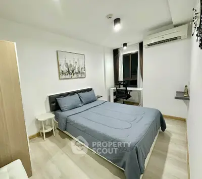 Modern bedroom with stylish decor and air conditioning in a cozy apartment.