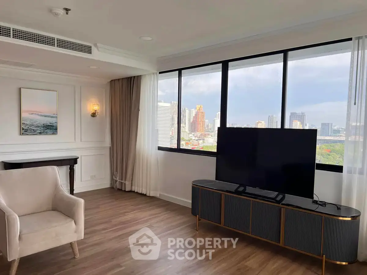 Spacious living room with city view, modern decor, and large windows in a high-rise apartment.