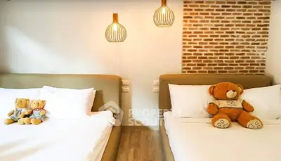 Charming bedroom with cozy beds and stylish lighting, perfect for relaxation.