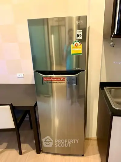 Modern stainless steel refrigerator in a stylish kitchen setting