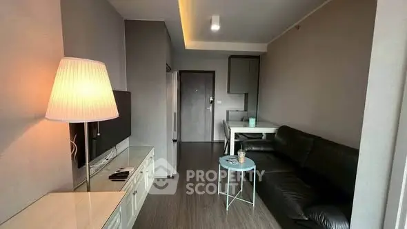 Modern living room with sleek black sofa and stylish lighting