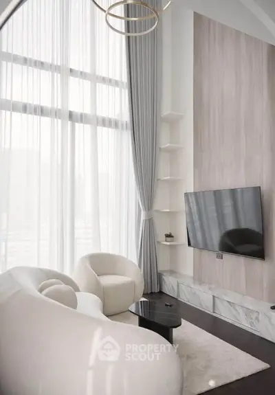 Luxurious modern living room with high ceilings, elegant furniture, and large windows for natural light.