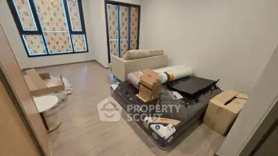 Spacious living room with modern flooring and large windows, ideal for cozy living.