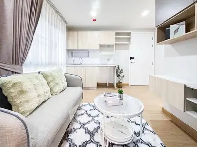 Modern living room with cozy sofa and open kitchen layout