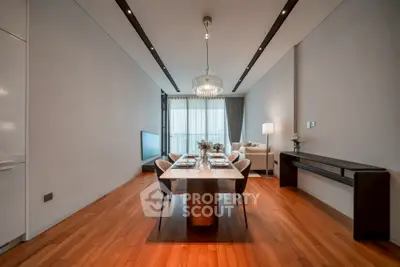 Elegant open-plan living and dining area with modern decor and hardwood floors.