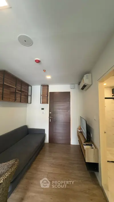 Modern living room with sleek furniture and wooden flooring