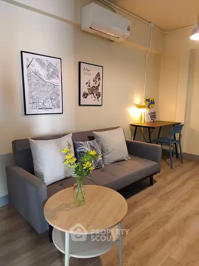 Stylish living room with modern decor and cozy seating in a contemporary apartment.
