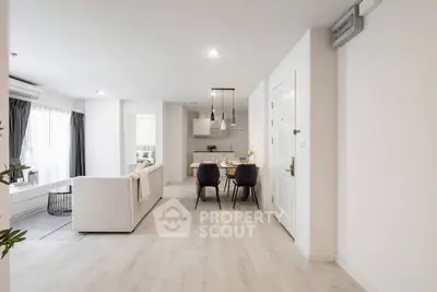 Modern open-plan living and dining area with stylish decor and natural light.