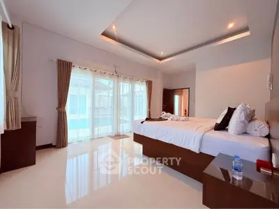 Spacious modern bedroom with large windows and elegant decor