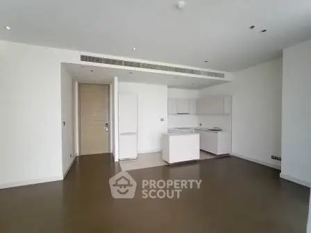 Spacious modern living room with open kitchen layout in a luxury apartment.