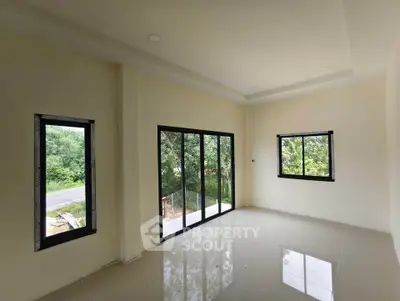 Spacious corner unit with large windows and serene green views