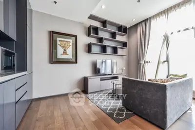 Modern living room with sleek furniture and large windows offering natural light.