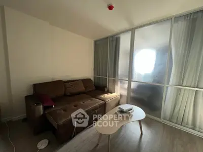 Cozy living room with brown sofa and modern coffee table, perfect for relaxation.