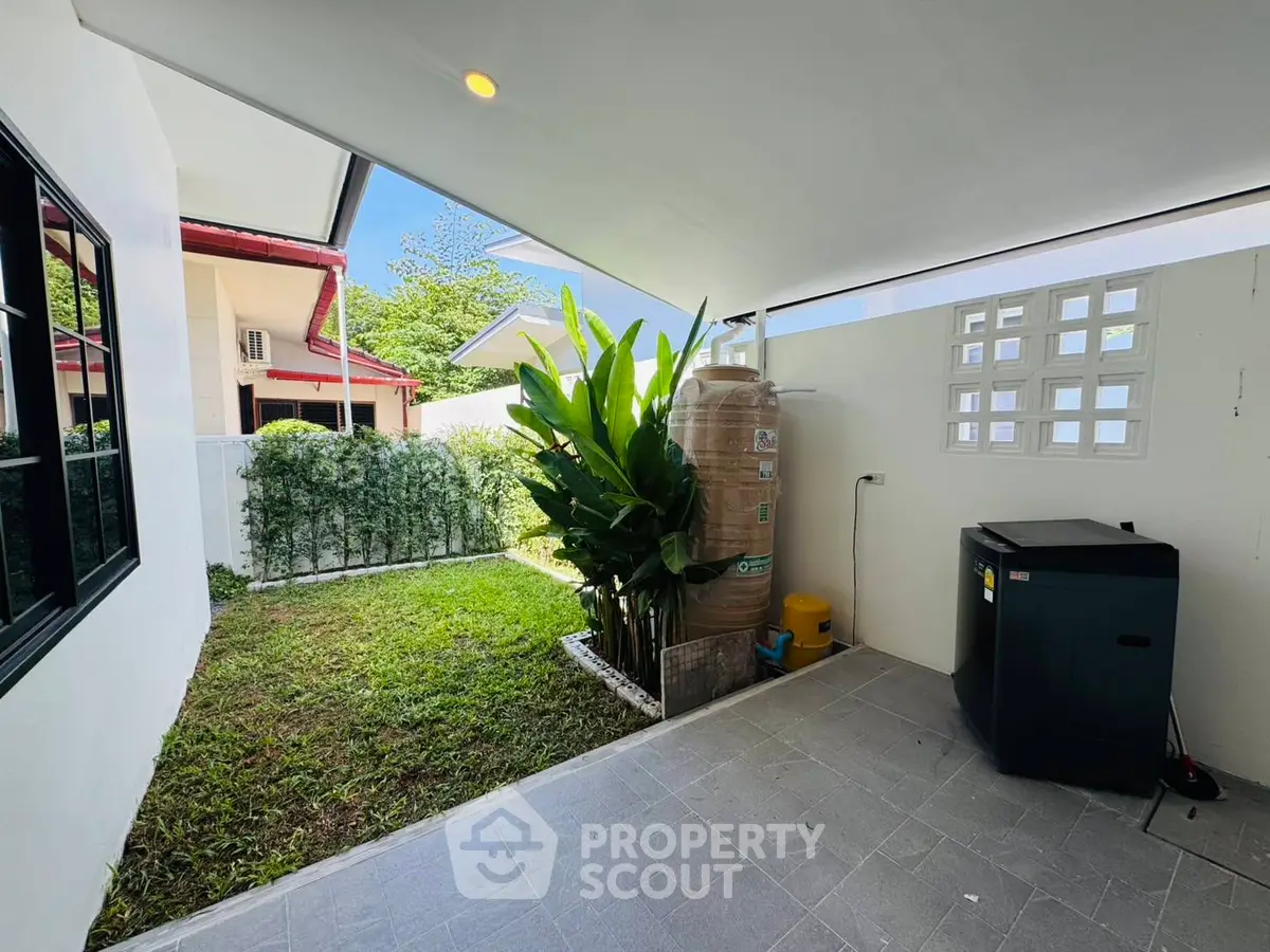 Charming garden view from covered patio with modern appliances