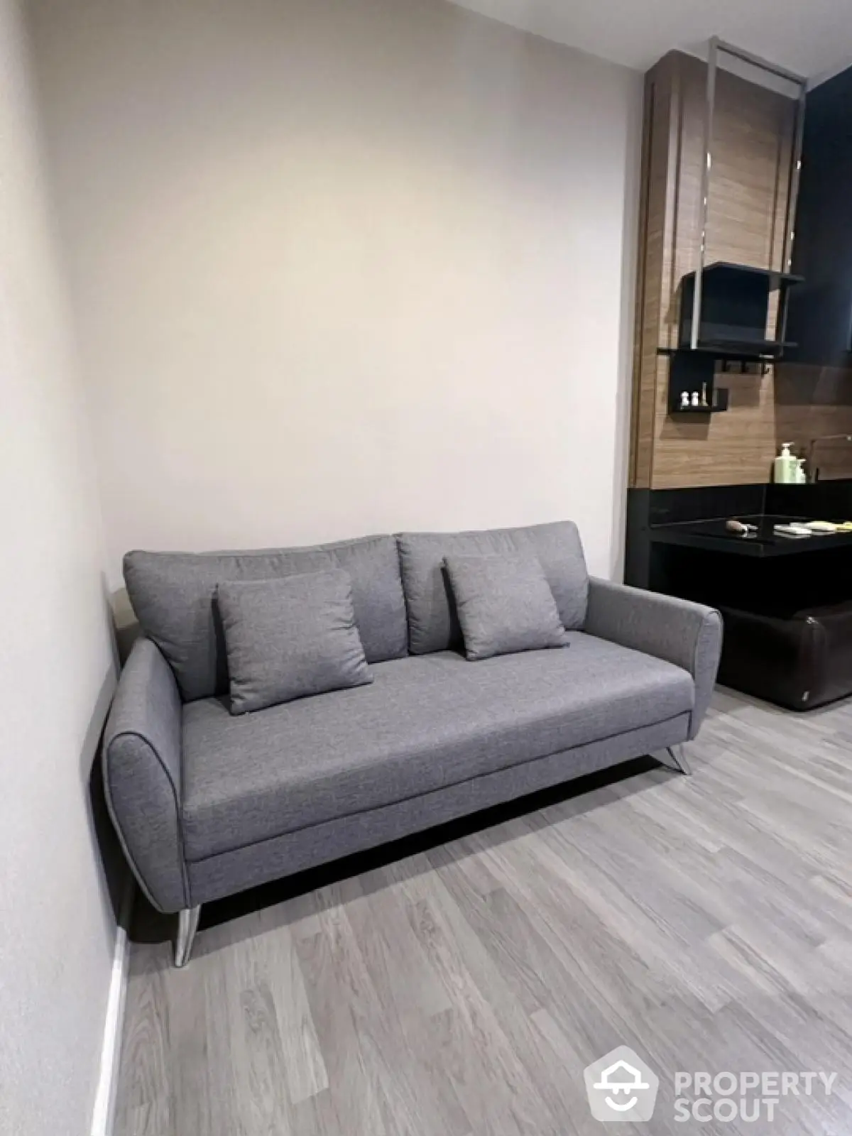 Modern living room with sleek gray sofa and stylish wooden accents