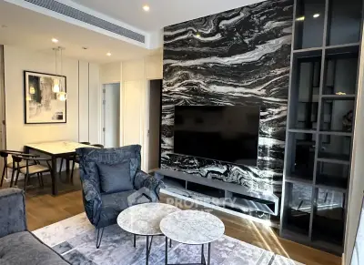 Luxurious living room with marble accent wall and modern furnishings