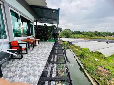 Spacious balcony with scenic garden and waterway views, perfect for relaxation and outdoor dining.