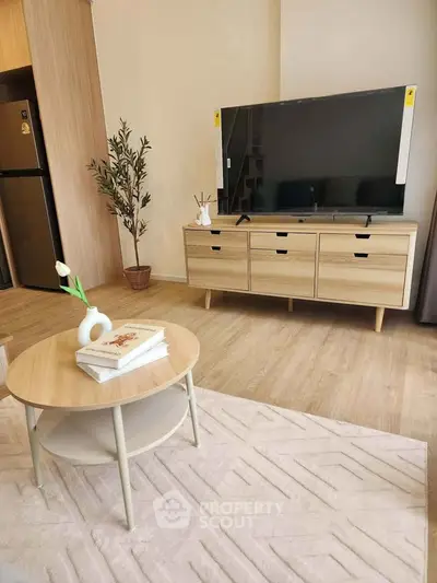 Modern living room with stylish furniture and large TV, perfect for cozy family gatherings.