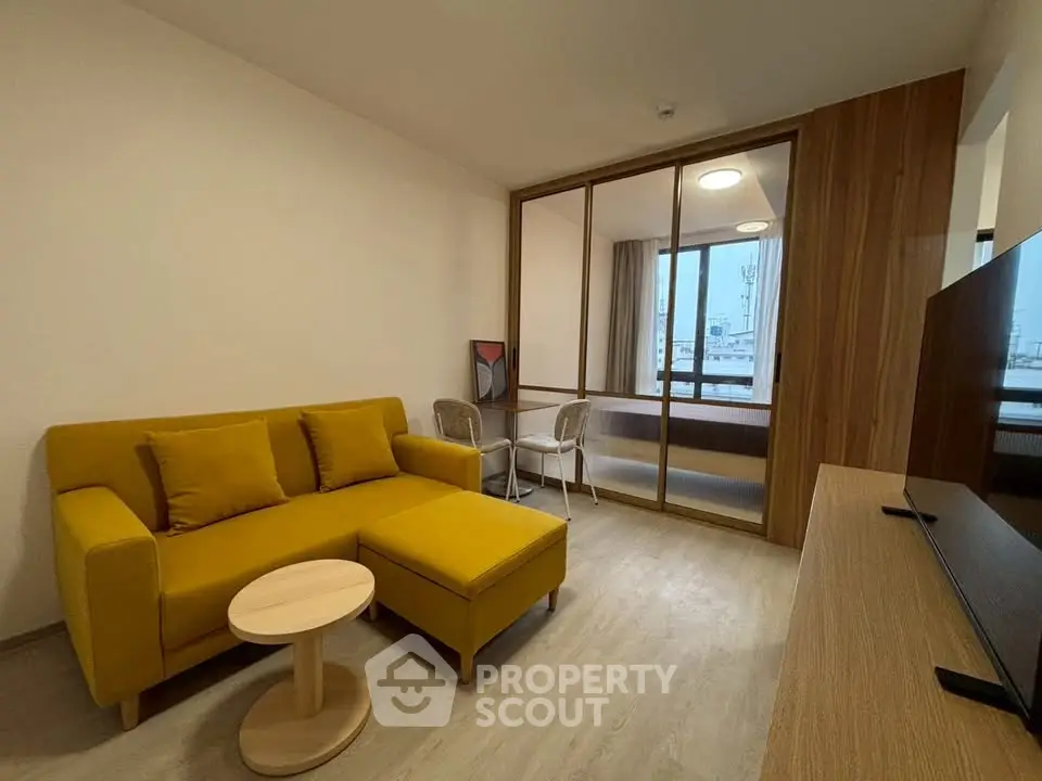 Modern living room with yellow sofa and wooden accents, featuring a cozy study nook.
