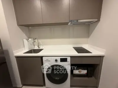 Modern compact kitchen with washing machine and induction cooktop