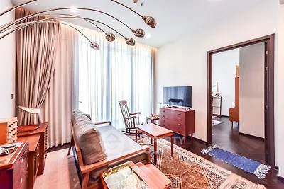 Charming living room with modern decor and natural light, featuring stylish furniture and a cozy ambiance.