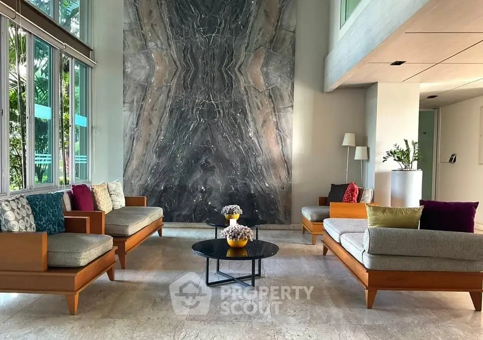 Elegant living room with modern furniture and stunning marble accent wall
