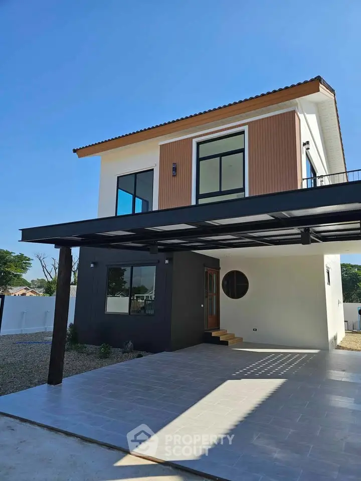 Modern two-story house with sleek design and spacious driveway