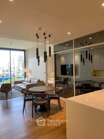 Modern living room with stylish furniture and city view balcony, perfect for urban living.