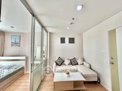 Modern living room with cozy sofa and glass partition to bedroom