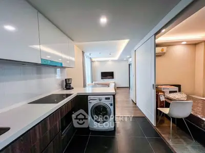Modern open kitchen with washing machine and sleek living area