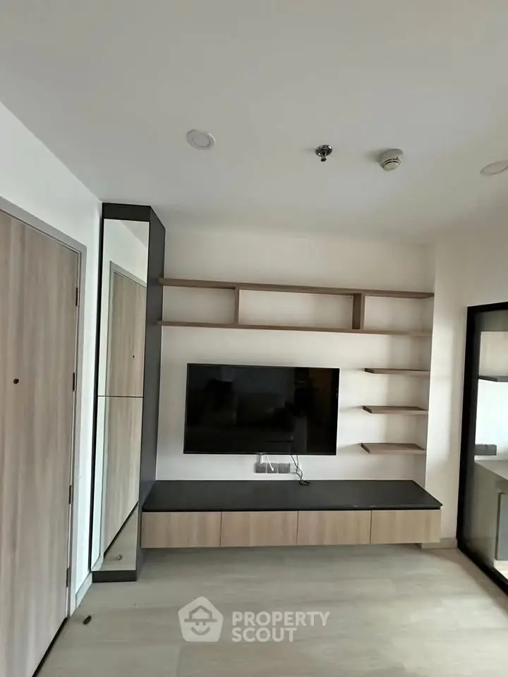 Modern living room with sleek TV unit and open shelving