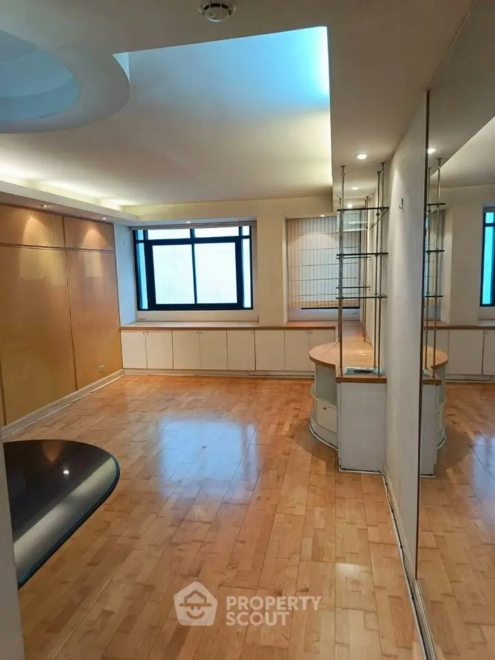 Spacious living room with wooden flooring and large window