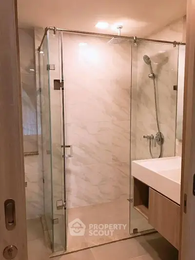 Modern bathroom with glass shower enclosure and sleek fixtures