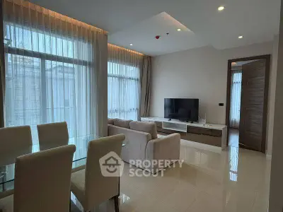 Spacious modern living room with elegant dining area and large windows.