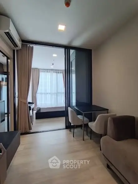 Modern living room with elegant furniture and large windows in a stylish apartment.