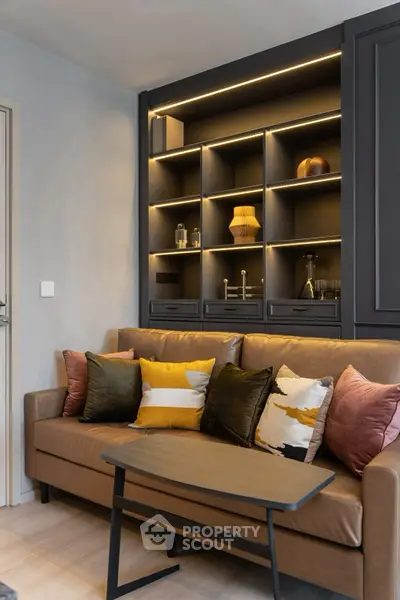 Stylish living room with modern shelving and cozy sofa, perfect for relaxation.