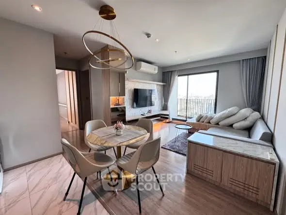 Modern living room with stylish furniture and large window offering a stunning view.