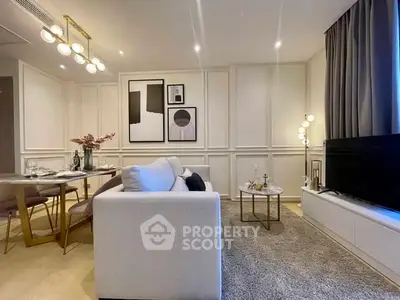 Modern living room with elegant decor and dining area, featuring stylish lighting and cozy ambiance.