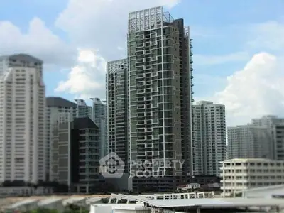 Modern high-rise building with unique architectural design in urban skyline.