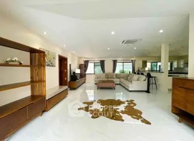Spacious modern living room with elegant furniture and open layout, perfect for family gatherings.