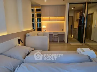 Modern bedroom with cozy lighting and stylish furniture, featuring a comfortable bed and a sleek study area.