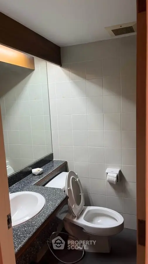 Modern bathroom with sleek fixtures and granite countertop