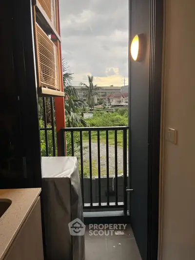 Charming small balcony with lush green view, perfect for relaxation and enjoying nature's tranquility.