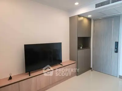 Modern living room with sleek TV setup and stylish cabinetry