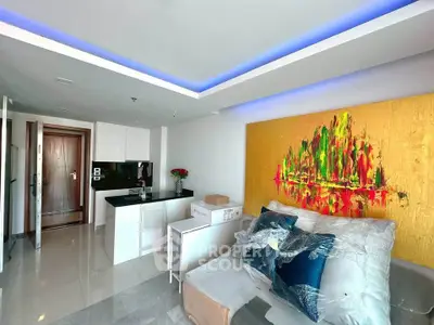 Modern living room with vibrant artwork and sleek kitchen design